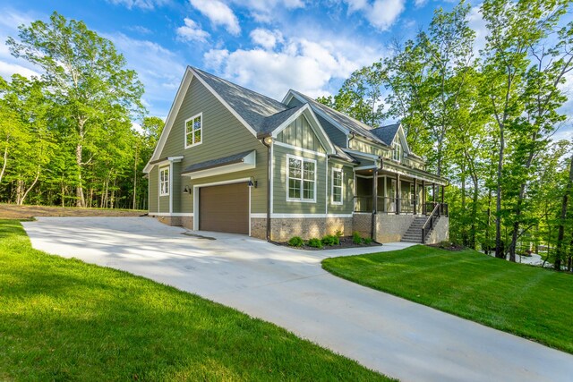 11570 Armstrong Rd, Soddy Daisy, TN 37379 - view of front of property featuring an attached garage, a front yard, concrete driveway, brick siding, and covered porch