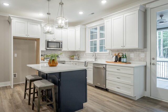 11570 Armstrong Rd, Soddy Daisy, TN 37379 - kitchen featuring stainless steel appliances, decorative backsplash, white cabinets, a kitchen breakfast bar, and recessed lighting
