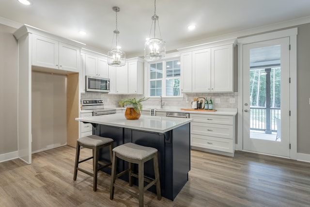 11570 Armstrong Rd, Soddy Daisy, TN 37379 - kitchen with appliances with stainless steel finishes, white cabinets, tasteful backsplash, light countertops, and crown molding