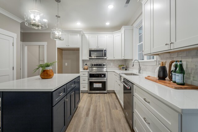 11570 Armstrong Rd, Soddy Daisy, TN 37379 - kitchen with appliances with stainless steel finishes, a sink, white cabinetry, light wood-type flooring, and decorative backsplash