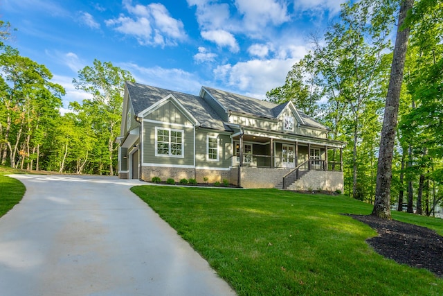 11570 Armstrong Rd, Soddy Daisy, TN 37379 - view of front of house with stairway, a front yard, concrete driveway, brick siding, and covered porch