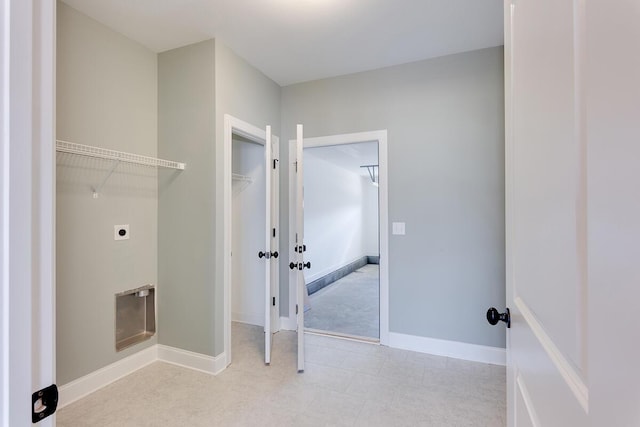 laundry room featuring electric dryer hookup and baseboards