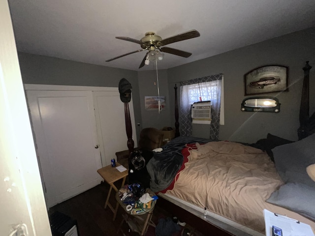 bedroom featuring a ceiling fan, wood finished floors, and cooling unit