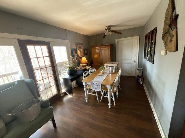 dining space with dark wood-type flooring, a ceiling fan, and lofted ceiling