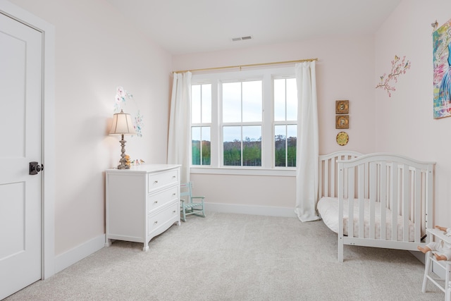 819 Morgan Rd NW, Charleston, TN 37310 - bedroom featuring light carpet, a nursery area, and baseboards