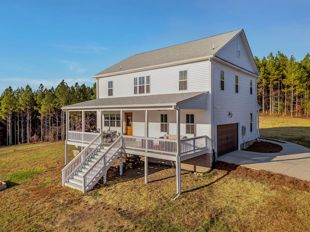 819 Morgan Rd NW, Charleston, TN 37310 - view of front facade featuring concrete driveway, a porch, a garage, and a front yard