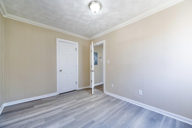 empty room featuring wood finished floors and baseboards
