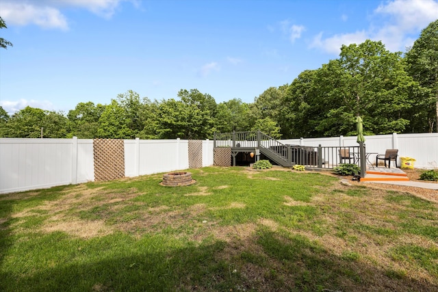 view of yard featuring an outdoor fire pit, a wooden deck, and stairs