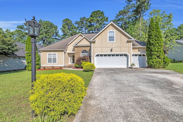 2123 Sargent Quick Dr, Chattanooga, TN 37421 - view of front of house with stucco siding, a front yard, driveway, and stone siding
