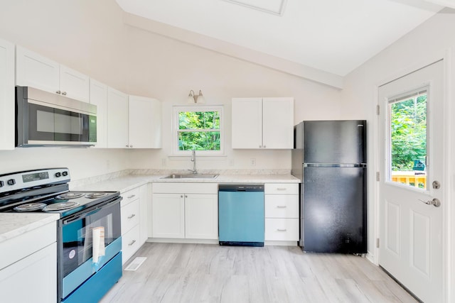 3910 Brock Rd, Chattanooga, TN 37421 - kitchen with stainless steel appliances, plenty of natural light, white cabinets, light wood-style flooring, and vaulted ceiling