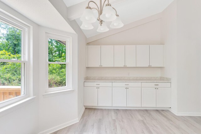 3910 Brock Rd, Chattanooga, TN 37421 - bar area featuring lofted ceiling, a chandelier, light wood-style flooring, and hanging light fixtures
