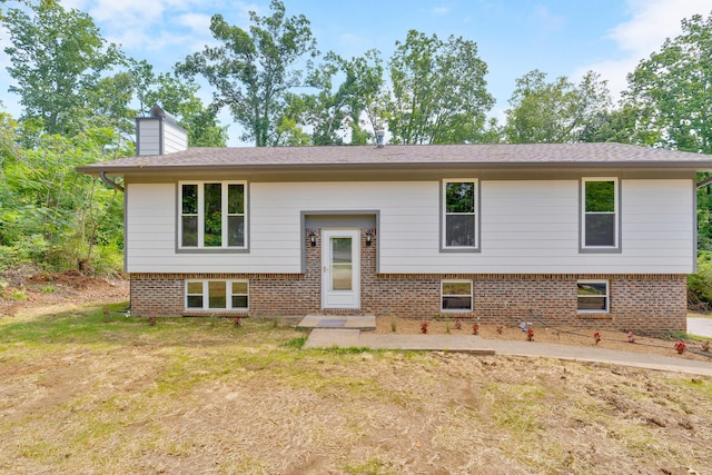 3910 Brock Rd, Chattanooga, TN 37421 - bi-level home with a chimney, a front lawn, and brick siding
