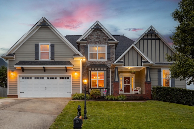 8802 Mckenzie Farm Dr, Ooltewah, TN 37363 - view of front of home featuring concrete driveway, a lawn, an attached garage, board and batten siding, and roof with shingles