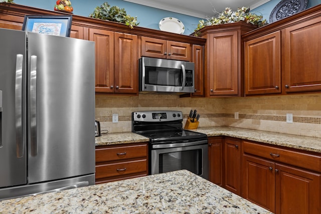 8802 Mckenzie Farm Dr, Ooltewah, TN 37363 - kitchen featuring stainless steel appliances, decorative backsplash, ornamental molding, light stone counters, and brown cabinets