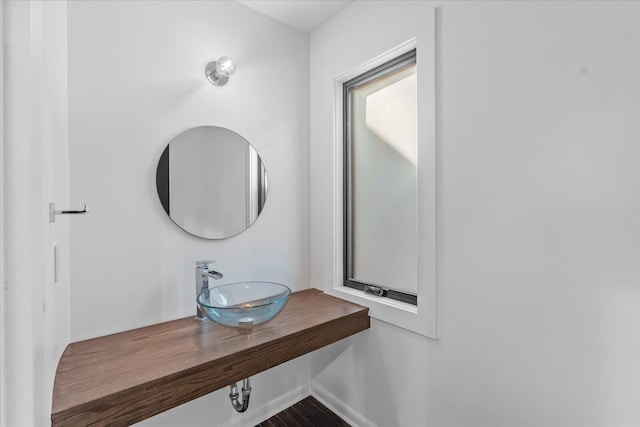 bathroom view of a sink and baseboards