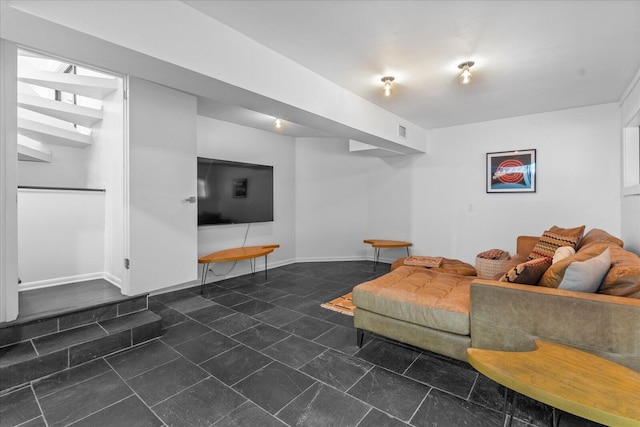 living area featuring baseboards