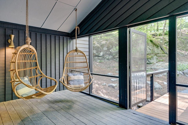 unfurnished sunroom with lofted ceiling
