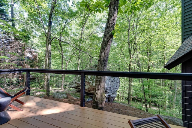 wooden terrace with a wooded view