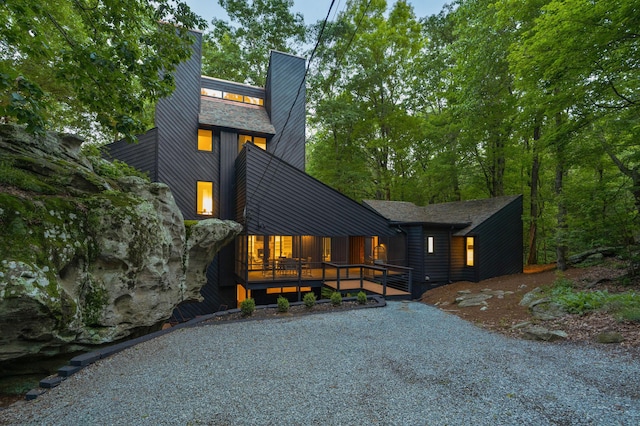view of front of home featuring covered porch and a chimney