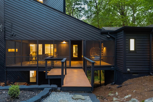 back of house with a deck