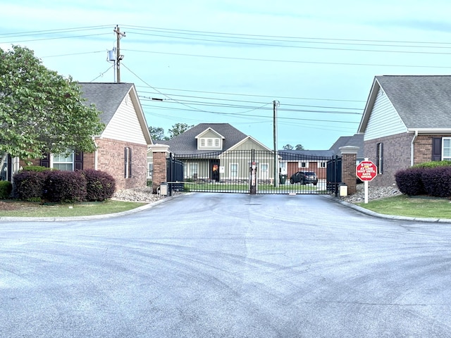 1501 Applebrook Dr, Rossville, GA 30741 - view of asphalt road featuring a gate, traffic signs, curbs, and a gated entry