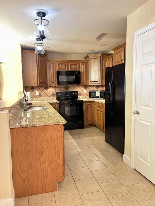 1501 Applebrook Dr, Rossville, GA 30741 - kitchen featuring black appliances, a sink, tasteful backsplash, brown cabinets, and light stone counters