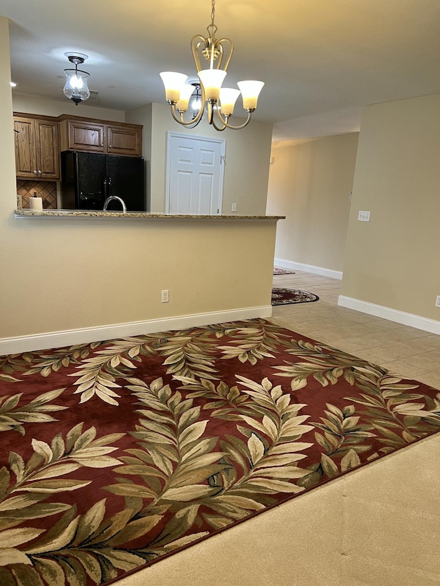 1501 Applebrook Dr, Rossville, GA 30741 - kitchen with black refrigerator with ice dispenser, a chandelier, pendant lighting, baseboards, and stone counters