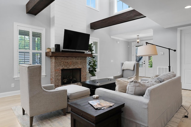 1328 Carrington Way, Chattanooga, TN 37405 - living room featuring a fireplace, light wood-style flooring, plenty of natural light, a high ceiling, and baseboards