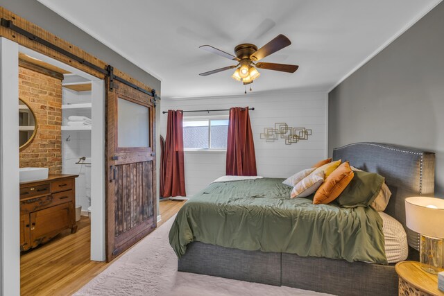 3804 Northview Ave, Chattanooga, TN 37412 - bedroom with a barn door, wood finished floors, ceiling fan, and connected bathroom