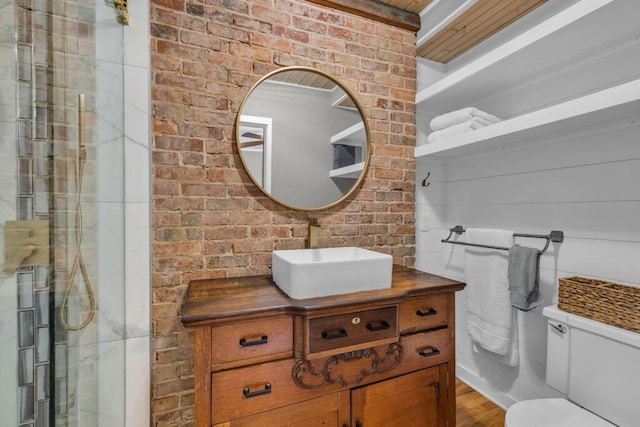3804 Northview Ave, Chattanooga, TN 37412 - bathroom featuring toilet, brick wall, wood finished floors, a shower with shower door, and vanity