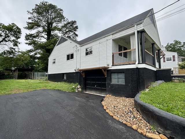 3804 Northview Ave, Chattanooga, TN 37412 - view of home's exterior with a balcony, a garage, driveway, and roof with shingles