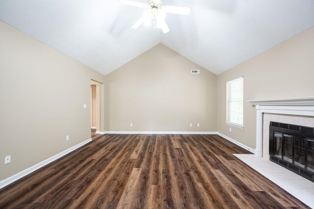 14 Castleview Ct, Ringgold, GA 30736 - unfurnished living room with a ceiling fan, wood finished floors, a tiled fireplace, lofted ceiling, and baseboards