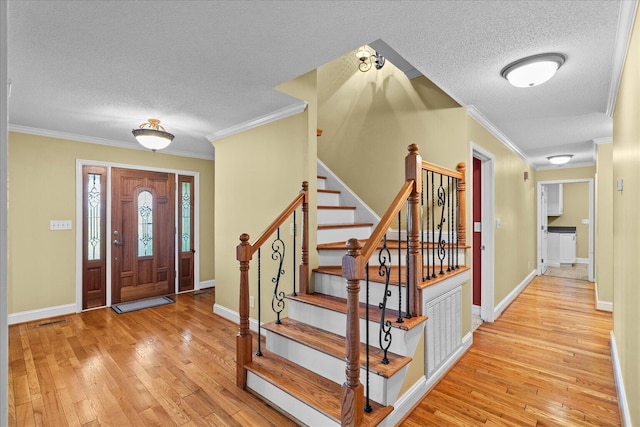 1578 Old Ringgold Rd, Rocky Face, GA 30740 - entryway with a textured ceiling, hardwood / wood-style floors, ornamental molding, baseboards, and stairs