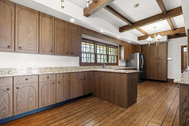 1116 Cumberland Rd, Chattanooga, TN 37419 - kitchen with freestanding refrigerator, a peninsula, beam ceiling, dark wood finished floors, and a chandelier
