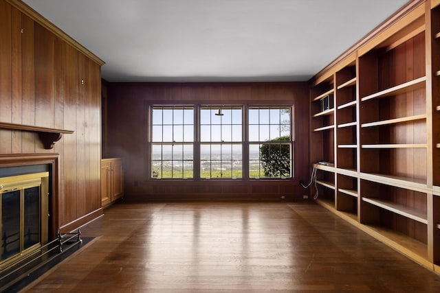 1116 Cumberland Rd, Chattanooga, TN 37419 - unfurnished living room with healthy amount of natural light, a glass covered fireplace, dark wood finished floors, and wooden walls