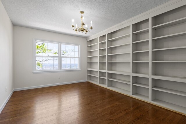 1116 Cumberland Rd, Chattanooga, TN 37419 - unfurnished room with a chandelier, a textured ceiling, wood finished floors, and built in features