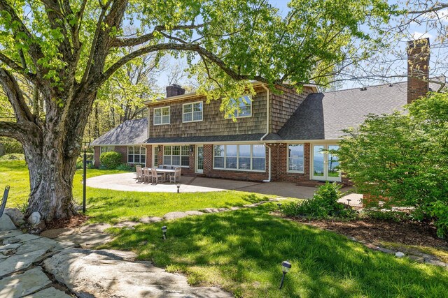 1116 Cumberland Rd, Chattanooga, TN 37419 - rear view of property featuring brick siding, a patio, a yard, a chimney, and french doors