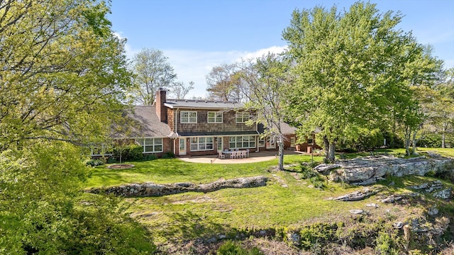 1116 Cumberland Rd, Chattanooga, TN 37419 - rear view of property featuring a chimney, a yard, and a patio area