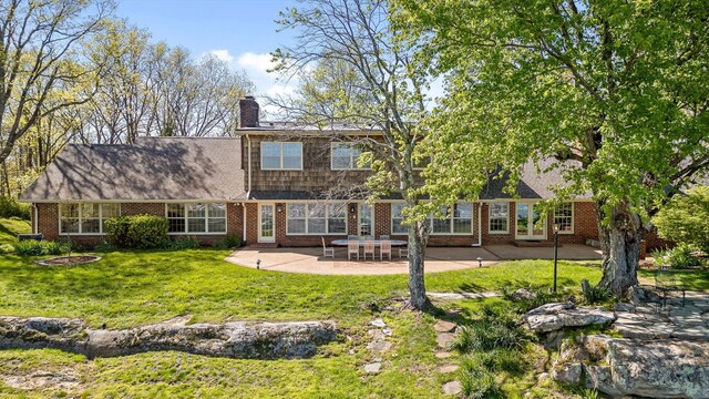 1116 Cumberland Rd, Chattanooga, TN 37419 - back of property with brick siding, a patio area, a chimney, and a lawn