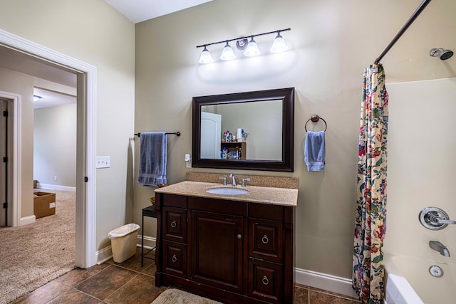 full bath with vanity, shower / bathtub combination with curtain, and baseboards