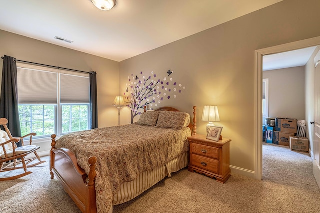 bedroom with light carpet and baseboards