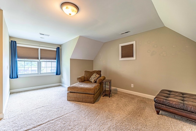 sitting room with carpet floors, lofted ceiling, and baseboards