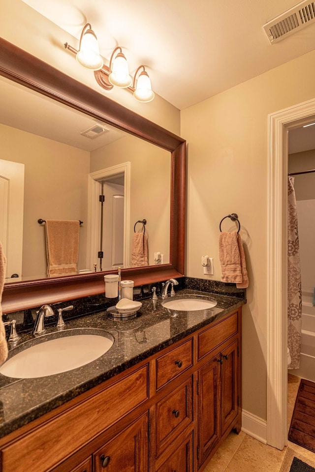 full bath featuring double vanity, tile patterned flooring, and shower / tub combo with curtain