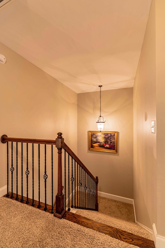 stairway with carpet and baseboards