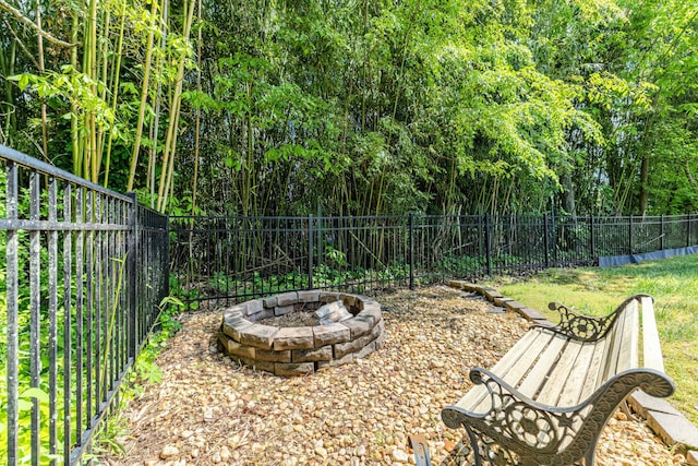 fenced backyard with a fire pit