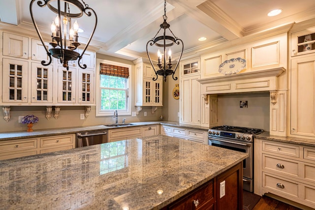 kitchen featuring a chandelier, appliances with stainless steel finishes, a sink, cream cabinets, and beam ceiling