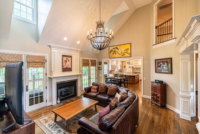 living room with high vaulted ceiling, dark wood-style flooring, a fireplace with flush hearth, baseboards, and plenty of natural light