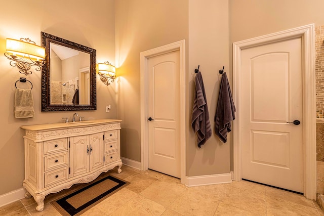 bathroom with baseboards and vanity