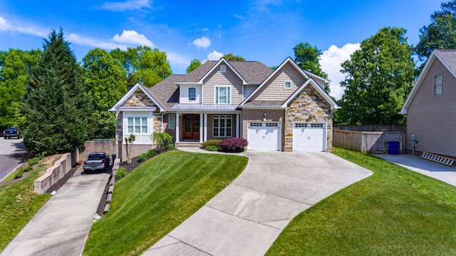 view of front of house featuring stone siding, concrete driveway, a garage, covered porch, and a standing seam roof