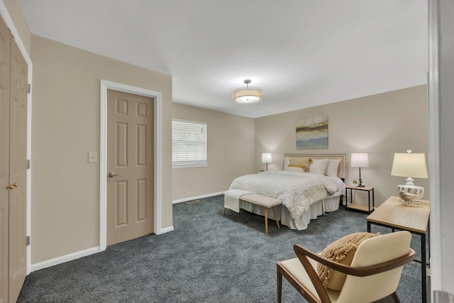 bedroom featuring dark colored carpet and baseboards